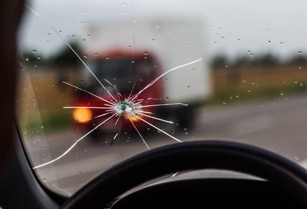 broken,windshield,of,a,car.,a,web,of,radial,splits,
